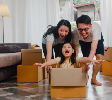 happy-asian-young-family-having-fun-laughing-moving-into-new-home-japanese-parents-mother-father-smiling-helping-excited-little-girl-riding-sitting-ca